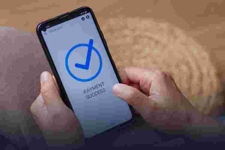 A South Asian man getting a fraudulent phone call on his smartphone. Voice phishing or Vishing alert message on device screen, selective focus